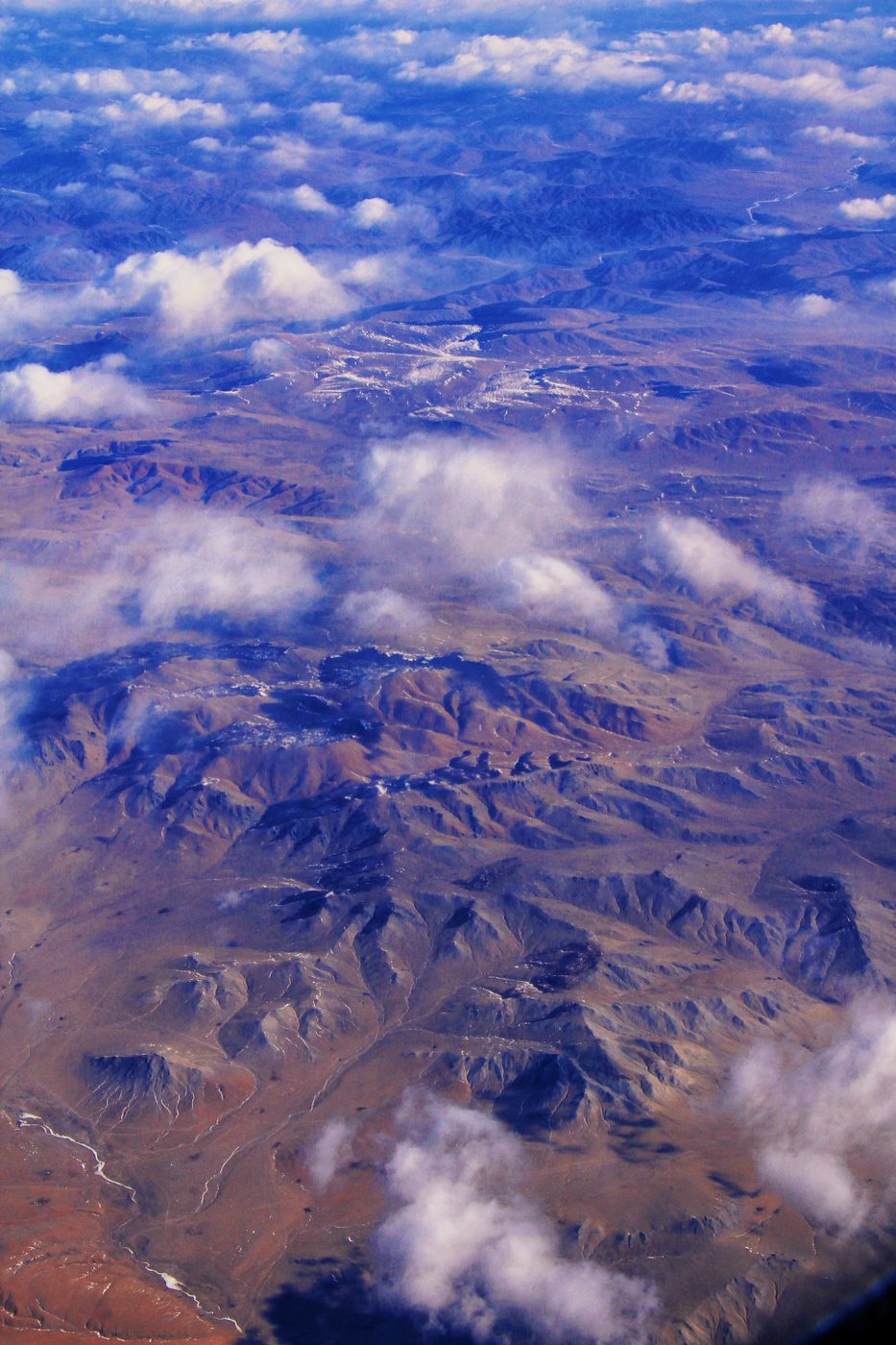 Mountains and clouds seen from an aeroplane window