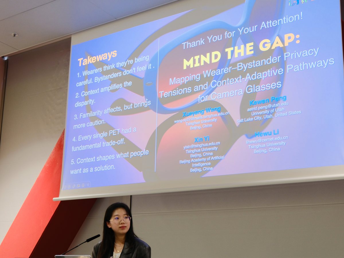 Astrid presenting Mind the Gap at a lectern, the final slide behind her